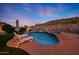 Inviting backyard pool with desert landscaping and lounge chairs, perfect for relaxation and enjoying the outdoors at 18121 W Las Cruces Dr, Goodyear, AZ 85338
