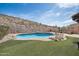 Inviting backyard pool with lounge chairs, patio space, and a desert landscape backdrop at 18121 W Las Cruces Dr, Goodyear, AZ 85338