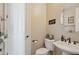 Charming powder room with pedestal sink, decorative mirror, and neutral wall color at 18121 W Las Cruces Dr, Goodyear, AZ 85338