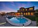 Stunning two-story home with a backyard oasis featuring a pool, spa, and covered patio area at 18121 W Las Cruces Dr, Goodyear, AZ 85338