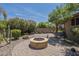 Lush backyard featuring a stone firepit and patio for outdoor entertaining at 1838 W Enfield Way, Chandler, AZ 85286