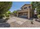 This backyard features a covered patio, pavers, gravel, and a fire pit, perfect for entertaining at 1838 W Enfield Way, Chandler, AZ 85286