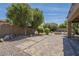 Backyard featuring pavers, mature landscaping, and fire pit at 1838 W Enfield Way, Chandler, AZ 85286