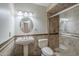 Elegant bathroom with tiled walk-in shower, pedestal sink, decorative lighting, and round vanity mirror at 1838 W Enfield Way, Chandler, AZ 85286