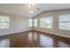 Spacious bedroom featuring gleaming hardwood floors, bright windows, and a vaulted ceiling at 1838 W Enfield Way, Chandler, AZ 85286