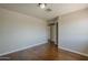 A cozy bedroom featuring neutral walls, wood floors, and two doorways at 1838 W Enfield Way, Chandler, AZ 85286