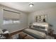 This bedroom boasts hardwood floors, a window and a comfortable bed with neutral decor at 1838 W Enfield Way, Chandler, AZ 85286