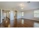 Open bedroom space with hardwood floors, high ceilings, bright lighting, and doorway access to hallway at 1838 W Enfield Way, Chandler, AZ 85286