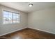 This bedroom has wood floors and a large window with a view of the neighborhood at 1838 W Enfield Way, Chandler, AZ 85286