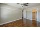 Bright bedroom featuring hardwood floors, ceiling fan and a convenient closet at 1838 W Enfield Way, Chandler, AZ 85286