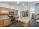 Functional kitchen with stainless steel appliances, wood cabinets, and an island at 1838 W Enfield Way, Chandler, AZ 85286