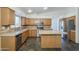 Spacious kitchen with stainless steel appliances, wood cabinetry, and tile flooring at 1838 W Enfield Way, Chandler, AZ 85286