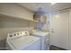This laundry room features a washer, dryer and shelf for storage at 1838 W Enfield Way, Chandler, AZ 85286