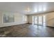 Spacious living room with tiled floors, abundant natural light from large windows, and access to the outdoors at 1838 W Enfield Way, Chandler, AZ 85286