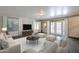 Bright living room features a neutral palette, tile floors, and double doors for a seamless indoor-outdoor lifestyle at 1838 W Enfield Way, Chandler, AZ 85286