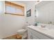 Bright bathroom featuring a sink vanity, mirrored cabinet, toilet and a window with wooden blinds at 18644 N 5Th Ave, Phoenix, AZ 85027