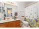 Bathroom with a flowered shower curtain, mirrored vanity, and white toilet at 18644 N 5Th Ave, Phoenix, AZ 85027
