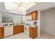 Bright kitchen with wooden cabinets, white countertops, and stainless steel sink at 18644 N 5Th Ave, Phoenix, AZ 85027