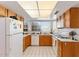 Kitchen featuring wooden cabinets, a window, and white appliances at 18644 N 5Th Ave, Phoenix, AZ 85027