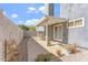 Enclosed patio with seating area, neutral-colored stucco walls and a variety of potted plants at 18644 N 5Th Ave, Phoenix, AZ 85027