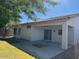 View of the home's backyard with a covered patio, small trees, and a manicured lawn at 20985 N 81St Dr, Peoria, AZ 85382