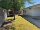 Exterior backyard with green grass, a concrete wall, and a glimpse of the house at 20985 N 81St Dr, Peoria, AZ 85382