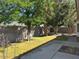 Backyard featuring healthy green grass, several mature trees, and a concrete block wall at 20985 N 81St Dr, Peoria, AZ 85382