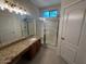 Bathroom features granite countertop vanity and tiled shower with sliding glass doors at 20985 N 81St Dr, Peoria, AZ 85382