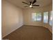 Bedroom with neutral colored carpet, base trim and large windows at 20985 N 81St Dr, Peoria, AZ 85382