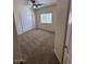 Cozy bedroom with neutral carpet, large window, and closet for storage at 20985 N 81St Dr, Peoria, AZ 85382