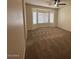 A spacious bedroom with a fan, neutral carpeting, and a large bay window at 20985 N 81St Dr, Peoria, AZ 85382
