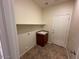 Functional laundry room with tile flooring, sink, storage cabinet, and convenient shelving at 20985 N 81St Dr, Peoria, AZ 85382