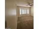 Comfortable living room with neutral carpet, bay window, and ceiling fan at 20985 N 81St Dr, Peoria, AZ 85382