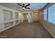 Spacious living room featuring built in shelving, neutral colors and large windows at 20985 N 81St Dr, Peoria, AZ 85382
