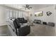 Comfortable living room with plush seating, a ceiling fan, and a wall-mounted TV for relaxation at 2144 E Honeysuckle Pl, Chandler, AZ 85286