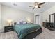 Comfortable main bedroom with plush carpet, ceiling fan, and dark wood furniture, creating a relaxing retreat at 2144 E Honeysuckle Pl, Chandler, AZ 85286