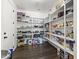 Walk-in pantry features white shelving, wood floors, and ample storage space for kitchen essentials at 2144 E Honeysuckle Pl, Chandler, AZ 85286