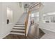 Staircase with wood and white trim leads to the upper level of this bright, modern home at 2144 E Honeysuckle Pl, Chandler, AZ 85286