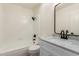 Updated bathroom featuring white cabinets, a black framed mirror, and tiled shower with black fixtures at 2220 S Cottonwood Dr, Tempe, AZ 85282