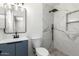 Modern bathroom featuring blue vanity, sleek mirror and walk in shower at 2220 S Cottonwood Dr, Tempe, AZ 85282