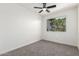 Cozy carpeted bedroom featuring a ceiling fan and neutral walls at 2220 S Cottonwood Dr, Tempe, AZ 85282