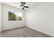 Bright bedroom featuring a ceiling fan, a window bringing in light, and neutral carpet at 2220 S Cottonwood Dr, Tempe, AZ 85282