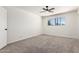 Bedroom featuring neutral carpet, a window with natural light, and a ceiling fan at 2220 S Cottonwood Dr, Tempe, AZ 85282