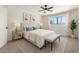Cozy bedroom with a ceiling fan, large bed, and bright window views at 2220 S Cottonwood Dr, Tempe, AZ 85282