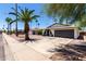 Charming single-story home featuring a well-manicured front yard and a two-car garage at 2220 S Cottonwood Dr, Tempe, AZ 85282