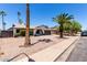 Single-story home featuring a well-manicured front yard and a two-car garage and desert landscaping at 2220 S Cottonwood Dr, Tempe, AZ 85282