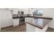 This open kitchen boasts stainless steel appliances, stylish backsplash, and white cabinets at 2220 S Cottonwood Dr, Tempe, AZ 85282