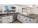 Kitchen view showcasing stainless dishwasher, gray counters, and backyard access at 2220 S Cottonwood Dr, Tempe, AZ 85282