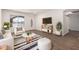 Bright living room with hardwood floors, a striped rug, and modern furniture at 2220 S Cottonwood Dr, Tempe, AZ 85282