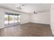 Open-concept living area with laminate flooring, leading to an outdoor patio and featuring modern fixtures at 2220 S Cottonwood Dr, Tempe, AZ 85282